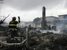 A firefighter surveys the smoldering ruins of a house in the Breezy Point section of New York. A firefighter surveys the smoldering ruins of a house in the Breezy Point section of New York.