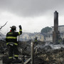 A firefighter surveys the smoldering ruins of a house in the Breezy Point section of New York.