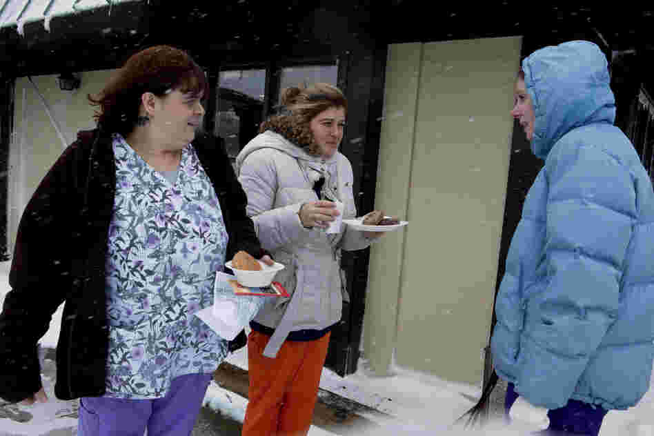 Tabatha Whitt, Hollie Acora and Erin Dowman, nurses at Raleigh General Hospital in Beckley, talk outside of a hotel where they stayed overnight to avoid driving in the heavy snow.