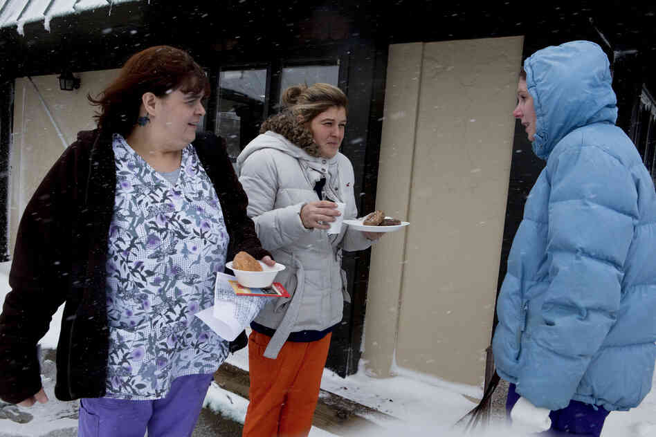 Tabatha Whitt, Hollie Acora and Erin Dowman, nurses at Raleigh General Hospital in Beckley, talk outside of a hotel where they stayed overnight to avoid driving in the heavy snow.