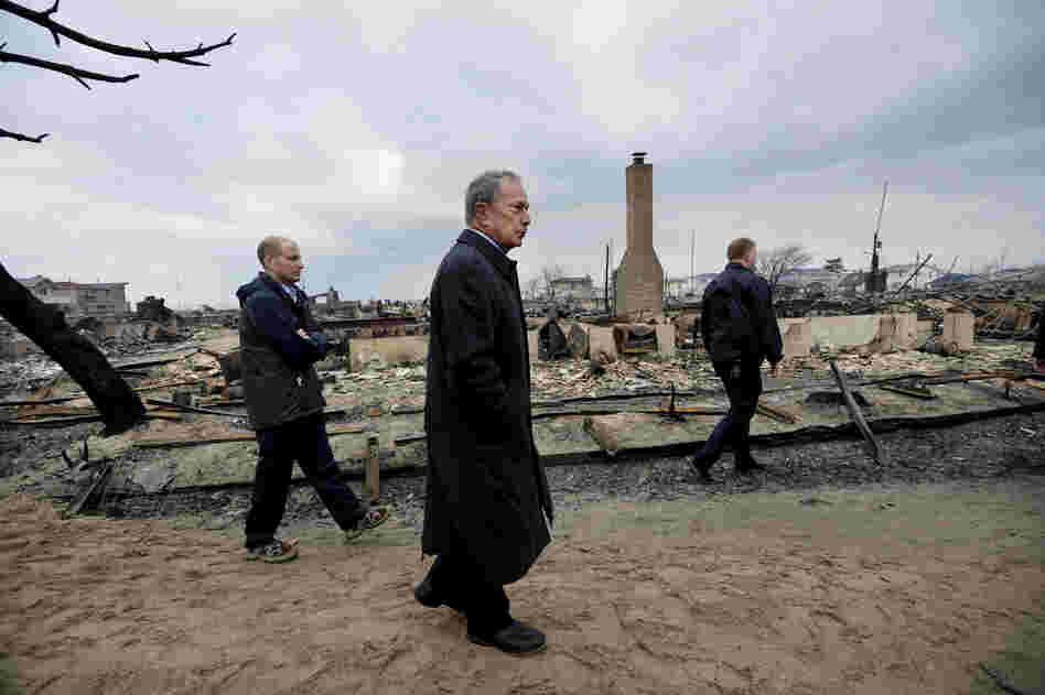 New York City Mayor Michael Bloomberg (center) views damage in the Breezy Point area of Queens, N.Y. Estimates of the damage caused by superstorm Sandy — including interruption of business activity and impact on infrastructure — range from $30 billion to $50 billion.