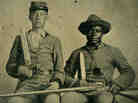 This rare portrait shows an identified Confederate noncommissioned officer, Sgt. Andrew Martin Chandler (left), and his named slave, Silas Chandler (right). It is the only Confederate photograph in the book by Rod Coddington, African American Faces of the Civil War. Born into slavery, Silas "was one of thousands of slaves who served as [body servants] during the war," writes Coddington.