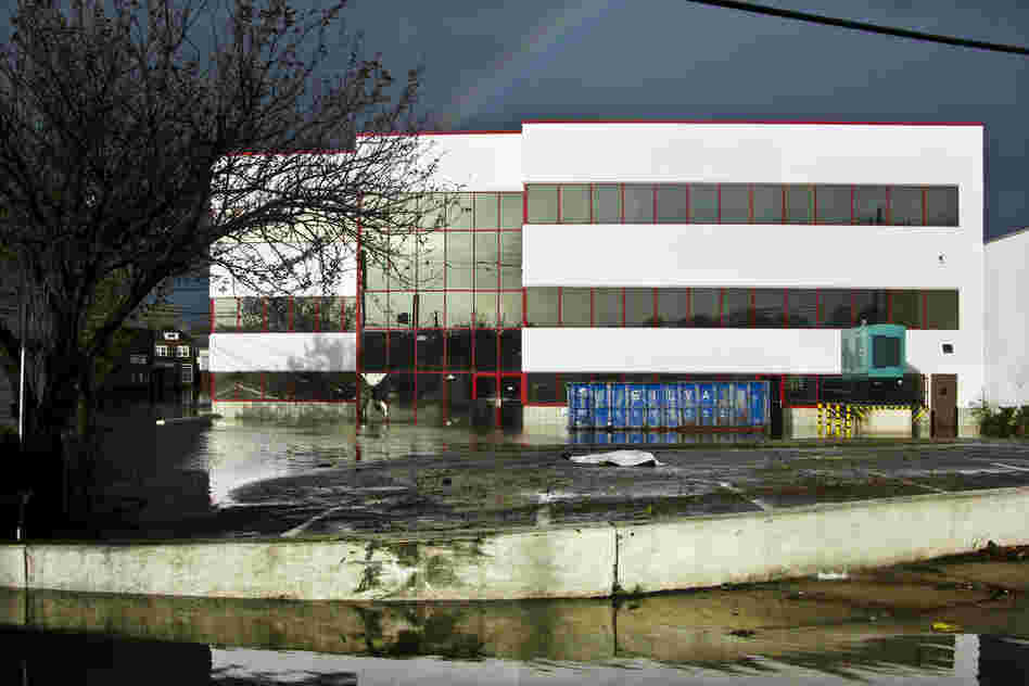 An unidentified body lies covered in a parking lot in Hackensack, NJ. According to local police, the body was found in the flooded lot with a stalled car nearby. Both Hackensack and Bergen County experienced considerable flooding due to last night's storm.