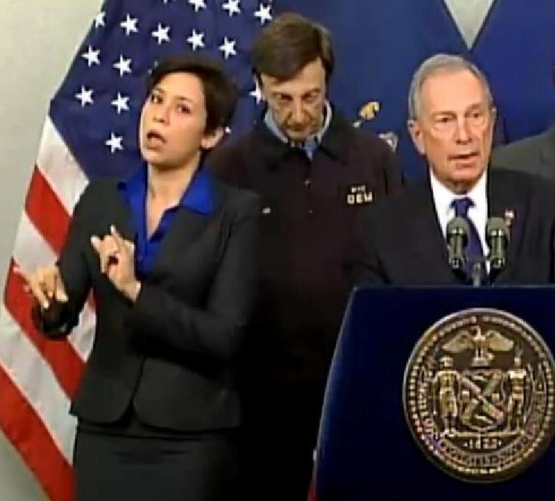 Fans like her style: Mayor Michael Bloomberg (at right) briefing New Yorkers about Hurricane Sandy on Monday. At left is his sign language interpreter, who the mayor identified as Lydia Callis.