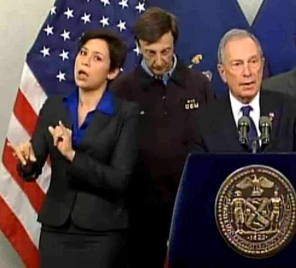 Fans like her style: Mayor Michael Bloomberg (at right) briefing New Yorkers about Hurricane Sandy on Monday. At left is his sign language interpreter, who the mayor identified as Lydia Callis.