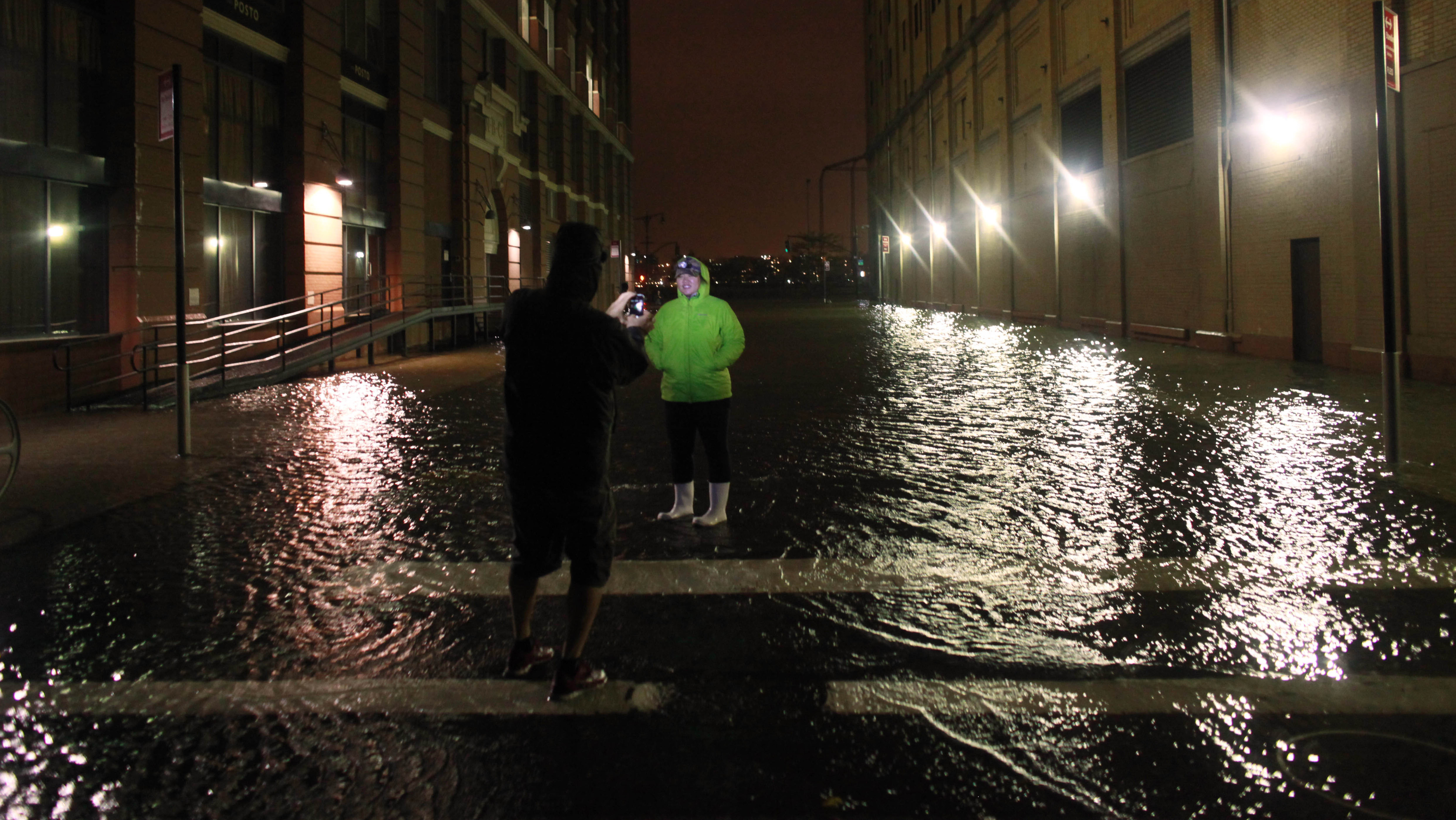 Picture-takers were out Monday night in Manhattan, where some streets were flooded. Picture-takers were out Monday night in Manhattan, where some streets were flooded.