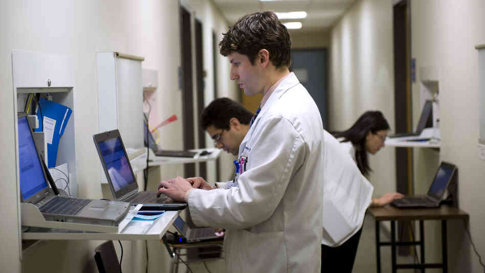 Students at Georgetown University School of Medicine  prepare to meet with an actor playing a patient in an exam room in March.
