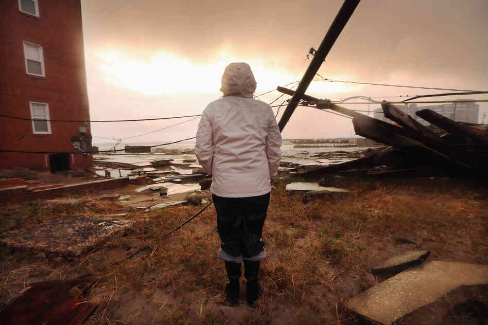 Kim Johnson inspects the area around her apartment building in Atlantic City, N.J. Johnson fled the area when the water began to rise Monday.