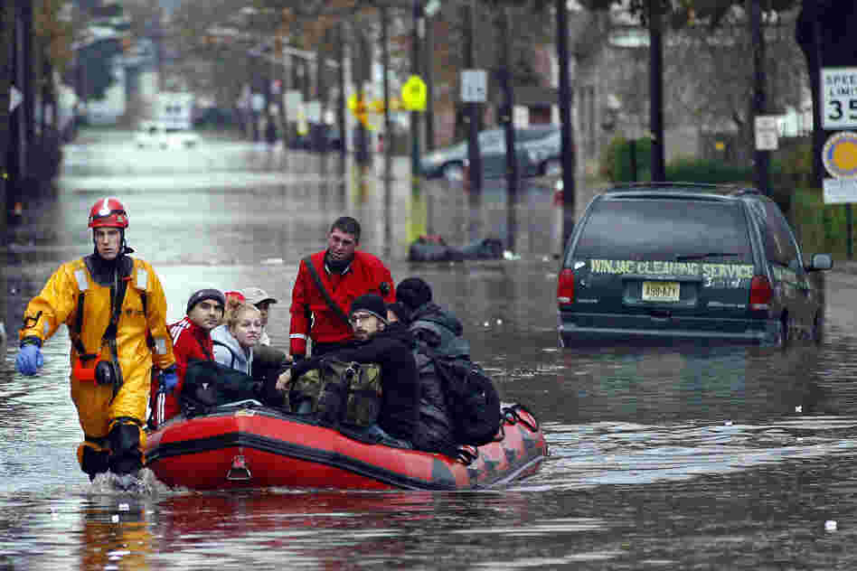 Emergency personnel rescue residents from flood waters brought on by Sandy in Little Ferry, N.J.