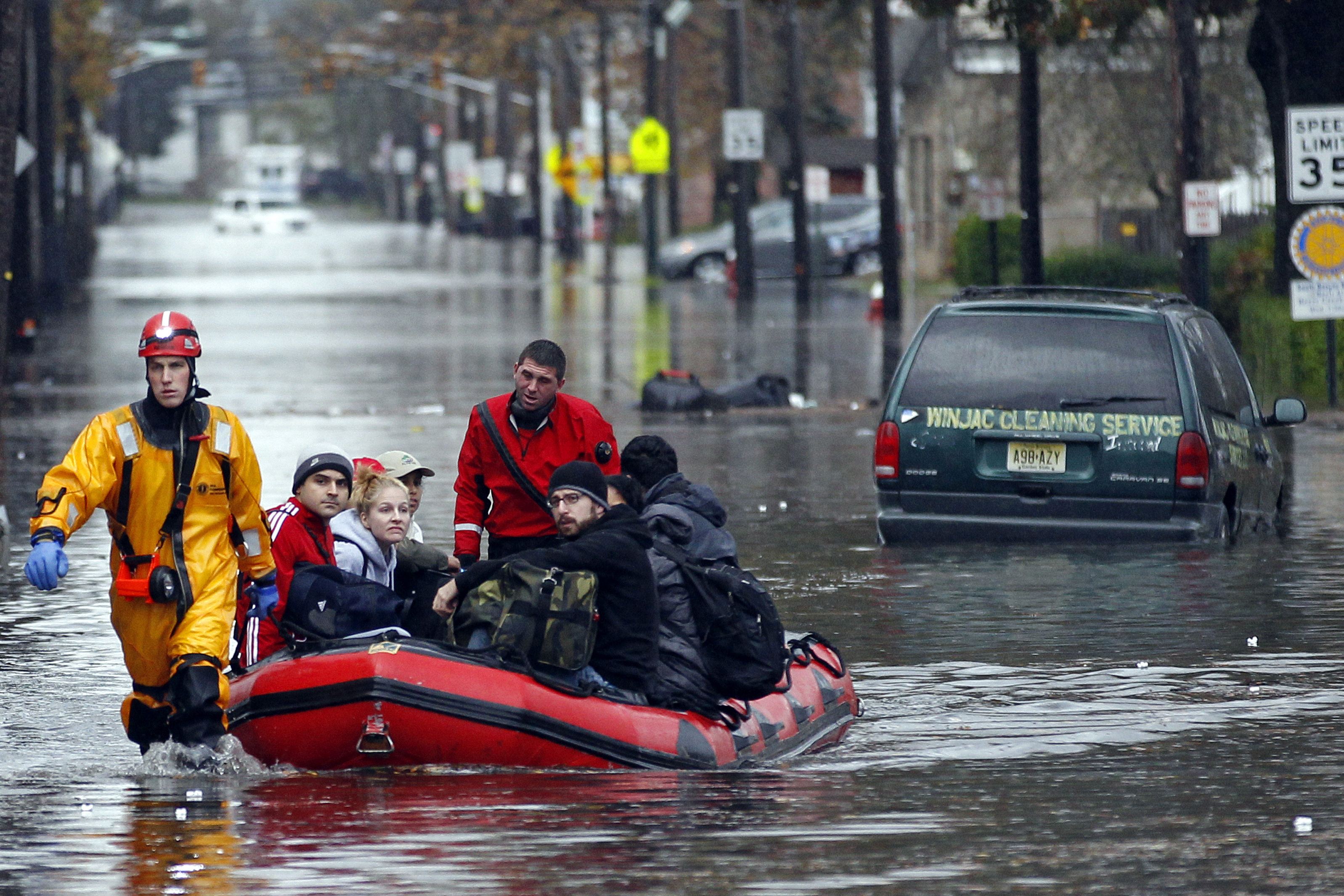 Emergency personnel rescue residents from flood waters brought on by Sandy in Little Ferry, N.J.