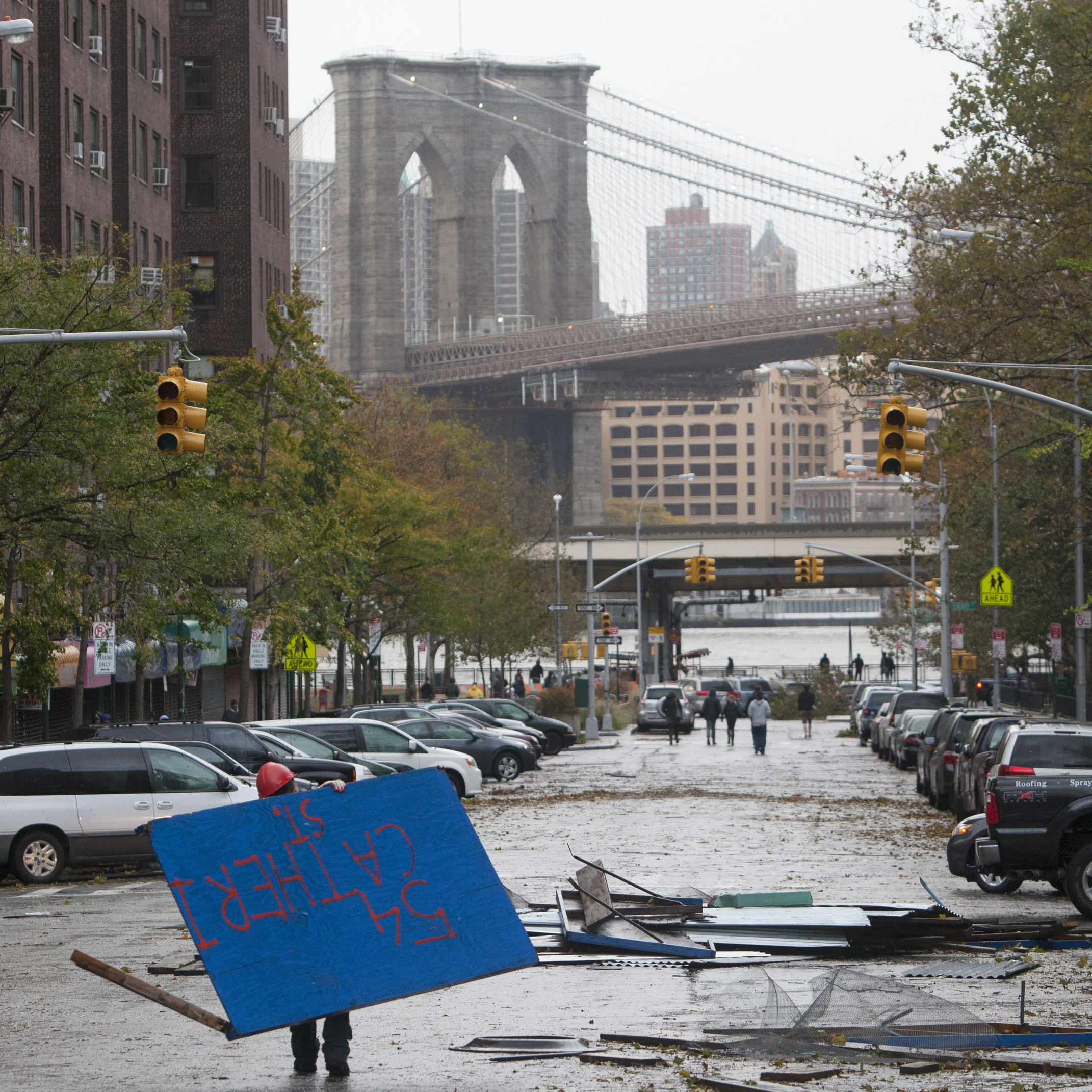 A worker picks up plywood from a scaffolding site in New York's Lower East Side in the aftermath of Sandy on Tuesday.