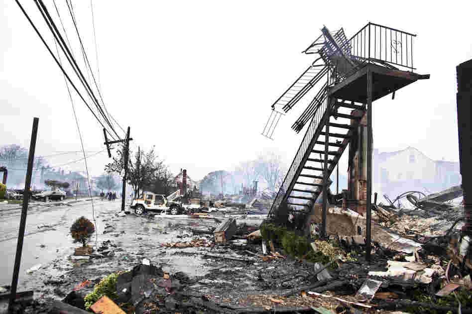 Dozens of homes and vehicles have been destroyed after a fire caused by Sandy, in Breezy Point neighborhood of Queens, N.Y. More than 190 firefighters contained the six-alarm blaze. According to The Associated Press, projected storm damage is between $10 billion and $20 billion.