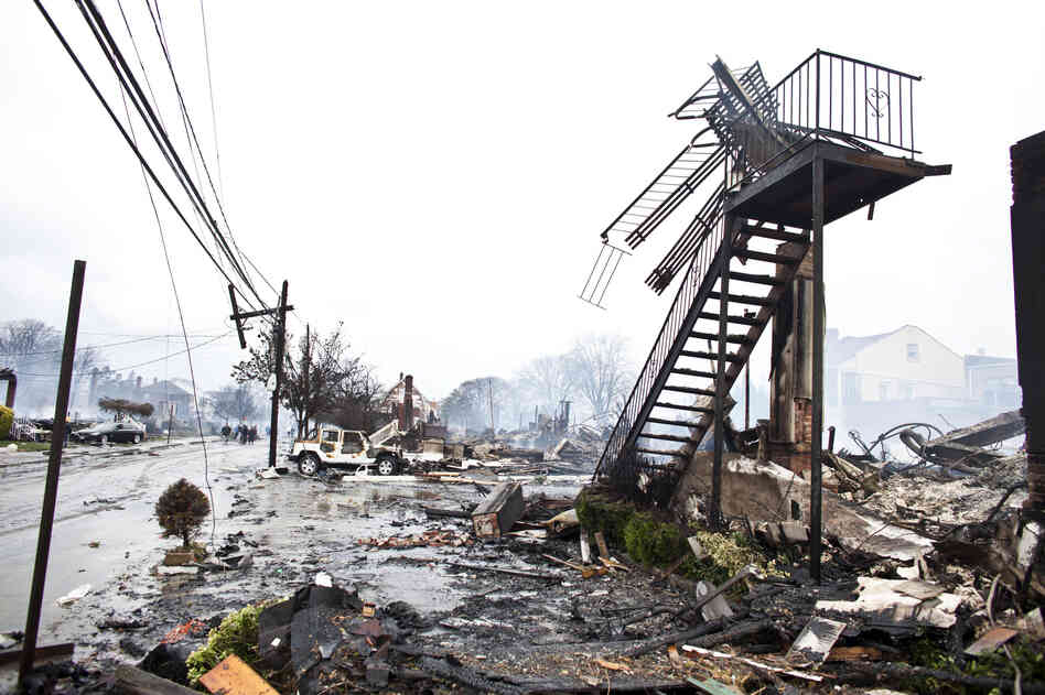 Dozens of homes and vehicles have been destroyed after a fire caused by Sandy, in Breezy Point neighborhood of Queens, N.Y. More than 190 firefighters contained the six-alarm blaze. According to The Associated Press, projected storm damage is between $10 billion and $20 billion.