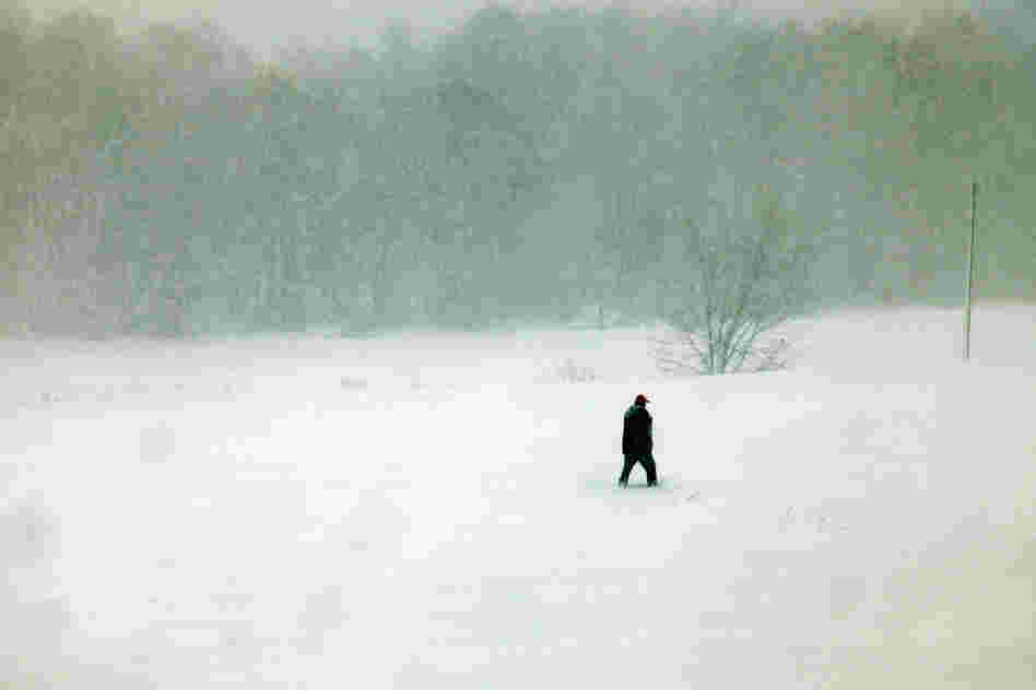 A person walks through snow in Belington, W.Va. Sandy buried parts of the state under more than a foot of snow, cutting power to at least 264,000 customers. Authorities closed nearly 50 miles of interstate.