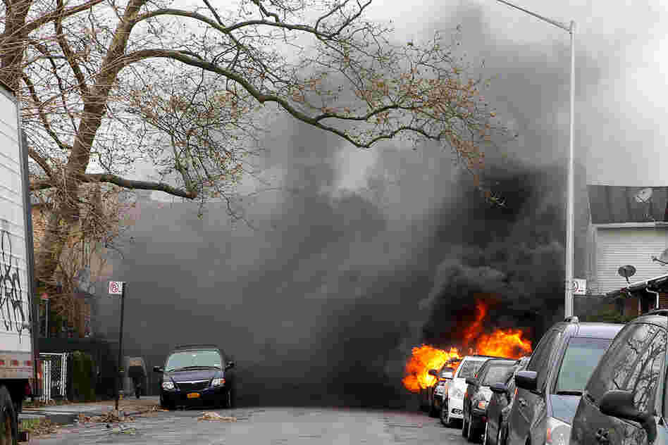 A car is seen on fire in the Brighton Beach neighborhood of Brooklyn, N.Y.