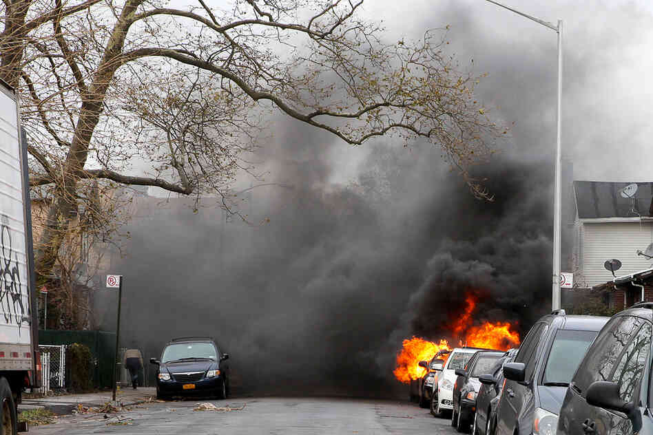 A car is seen on fire in the Brighton Beach neighborhood of Brooklyn, N.Y.