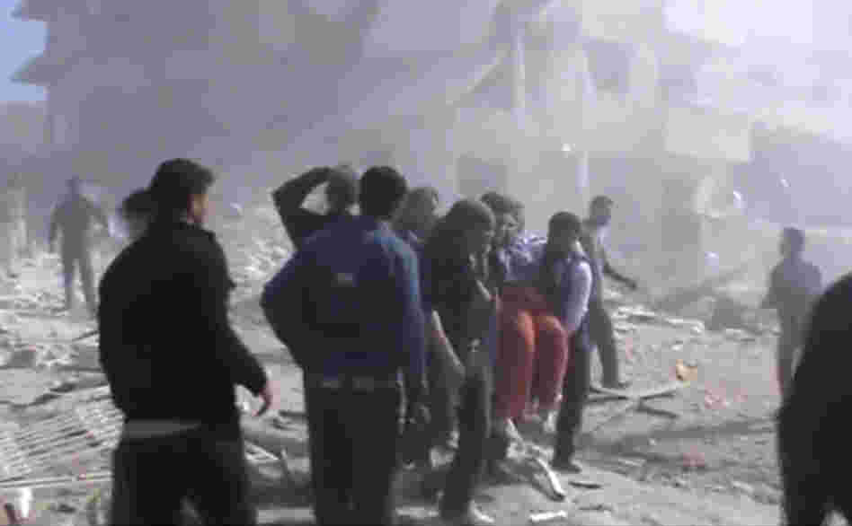 An image taken from video obtained from the Shaam News Network, authenticated by AP reporting, shows attempts to rescue the wounded in Idlib, northern Syria following heavy bombing from military warplanes.