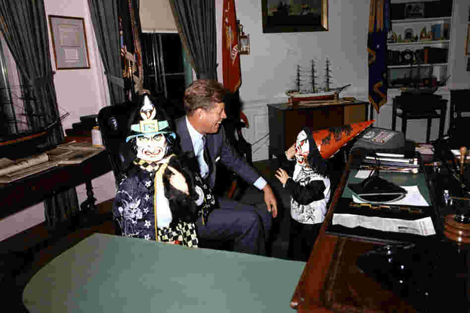 President John F. Kennedy Jr., greets Halloween visitors in the Oval Office, 1963. Bonus: That is a kitten in the child's hand on the left.