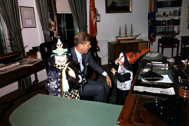 President John F. Kennedy Jr., greets Halloween visitors in the Oval Office, 1963. Bonus: That is a kitten in the child's hand on the left.