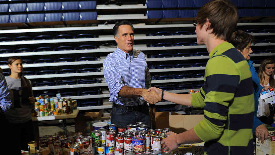 Mitt Romney helps collect and pack donated goods for those affected by Hurricane Sandy, in Kettering, Ohio, on Tuesday.