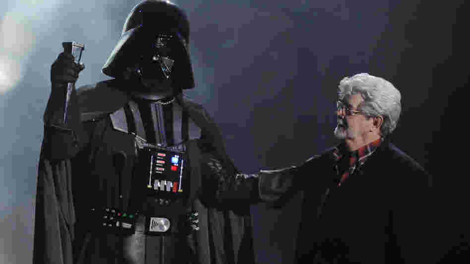 In this Oct. 15, 2011 file photo, "Darth Vader" accepts the Ultimate Villain award from Star Wars creator George Lucas during the 2011 Scream Awards.