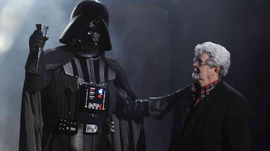 In this Oct. 15, 2011 file photo, "Darth Vader" accepts the Ultimate Villain award from Star Wars creator George Lucas during the 2011 Scream Awards.