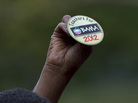 An attendee holds up a button at a speech by President Obama on Sept. 17 in Cincinnati. An attendee holds up a button at a speech by President Obama on Sept. 17 in Cincinnati.