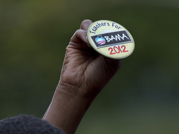 An attendee holds up a button at a speech by President Obama on Sept. 17 in Cincinnati.