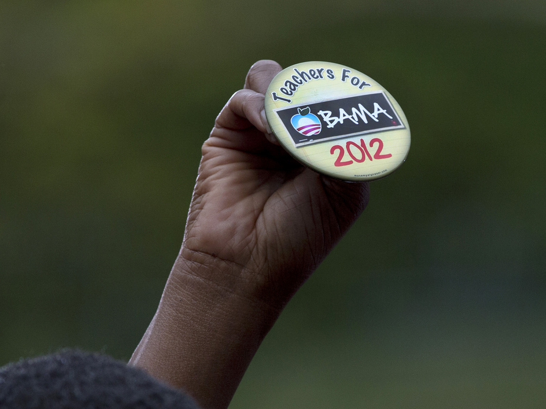 An attendee holds up a button at a speech by President Obama on Sept. 17 in Cincinnati.