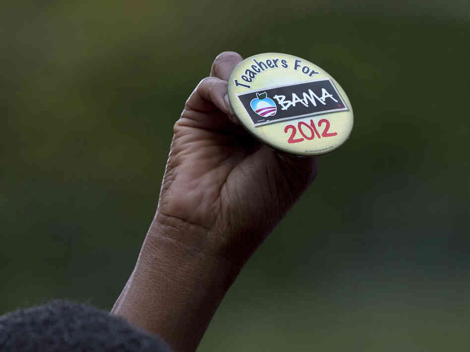 An attendee holds up a button at a speech by President Obama on Sept. 17 in Cincinnati.