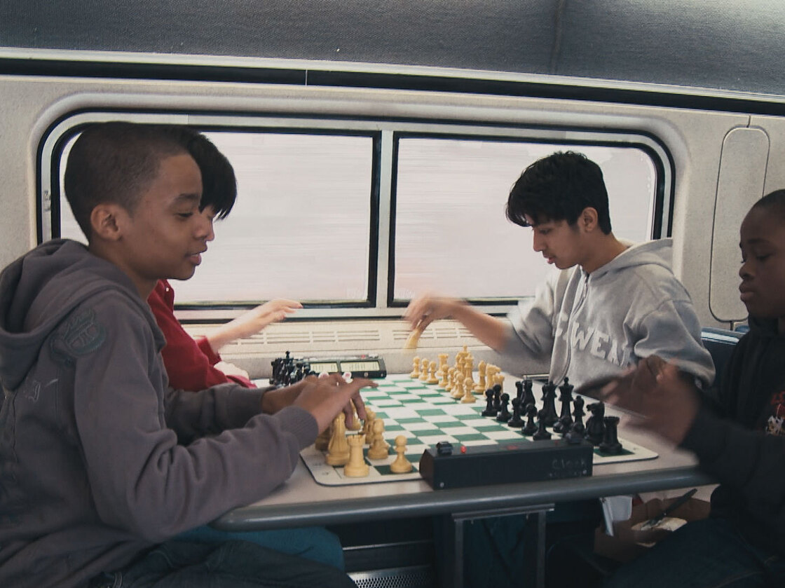 These up-and-coming Bobby Fischers are always sharpening their game. Instead or napping of texting, they practice on the train.