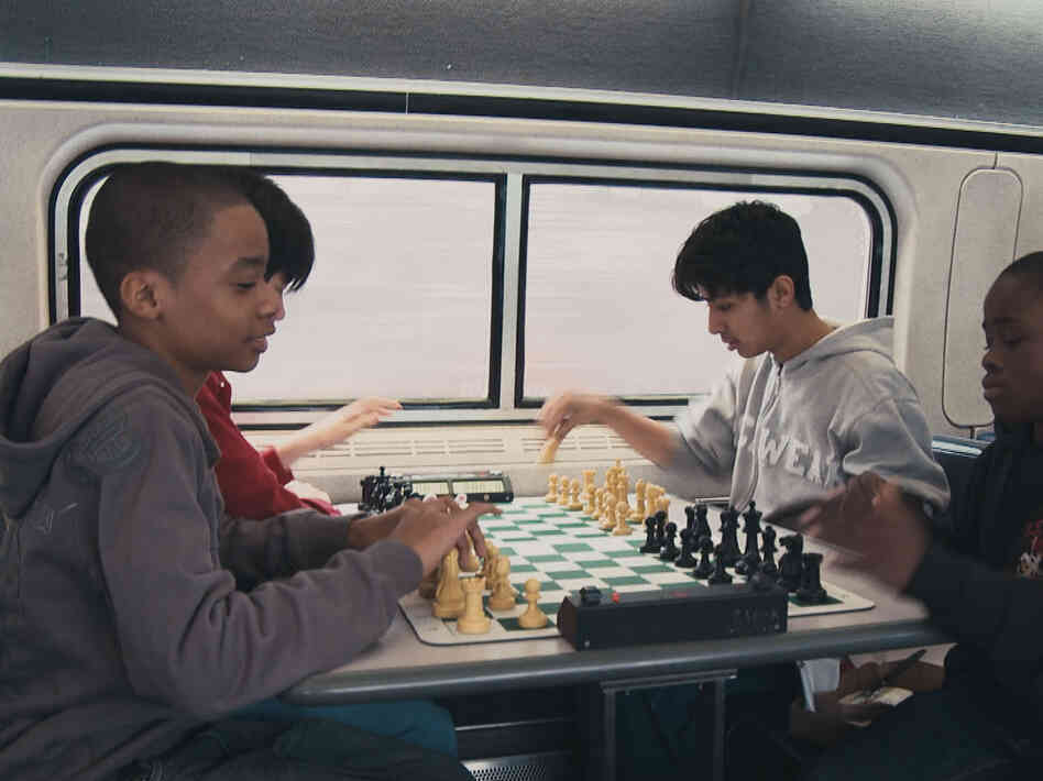 These up-and-coming Bobby Fischers are always sharpening their game. Instead or napping of texting, they practice on the train.