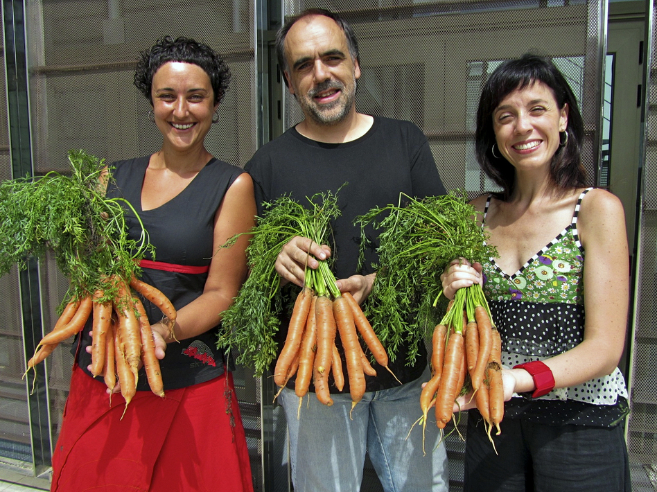 At the Bescan&oacute; municipal theater in northeastern Spain, director Quim Marc&eacute; (center) and actresses Meritxell Yanes (left) and Elena Martinell (right) display carrots for sale.