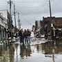 People look at homes and businesses destroyed during Superstorm Sandy on Tuesday in the Rockaway section of Queens, N.Y.