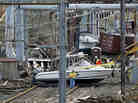 Workers try to clear boats and debris from the New Jersey Transit's Morgan draw bridge on Wednesday in South Amboy, N.J., after Monday's storm surge from Sandy pushed boats and cargo containers onto the train tracks.