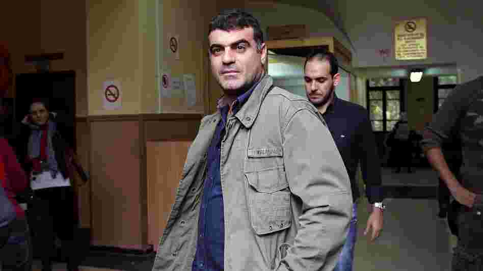 Journalist Kostas Vaxevanis waits to appear in court in Athens on Monday. Vaxevanis was arrested for the publication of 2,059 names of people alleged to have accounts in a Swiss bank. Journalist Kostas Vaxevanis waits to appear in court in Athens on Monday. Vaxevanis was arrested for the publication of 2,059 names of people alleged to have accounts in a Swiss bank.