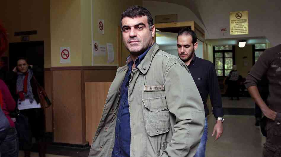 Journalist Kostas Vaxevanis waits to appear in court in Athens on Monday. Vaxevanis was arrested for the publication of 2,059 names of people alleged to have accounts in a Swiss bank. Journalist Kostas Vaxevanis waits to appear in court in Athens on Monday. Vaxevanis was arrested for the publication of 2,059 names of people alleged to have accounts in a Swiss bank.