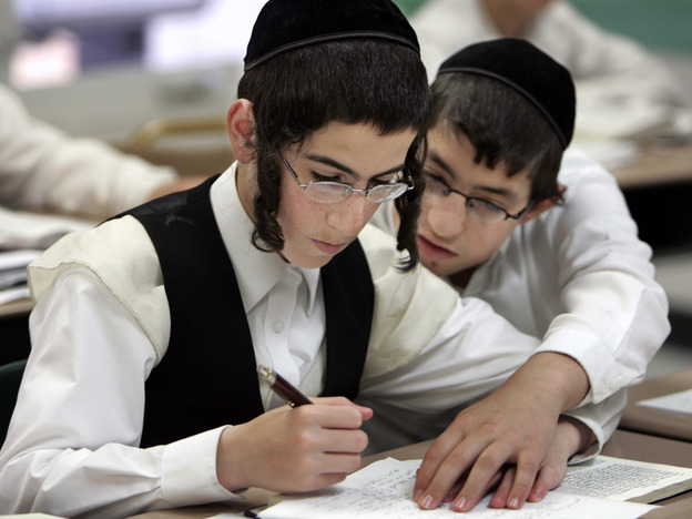 Two boys study together at a Chicago yeshiva in 2009. Public health officials say this type of close physical contact caused a mumps outbreak to spread throughout several orthodox Jewish communities in and around New York City.