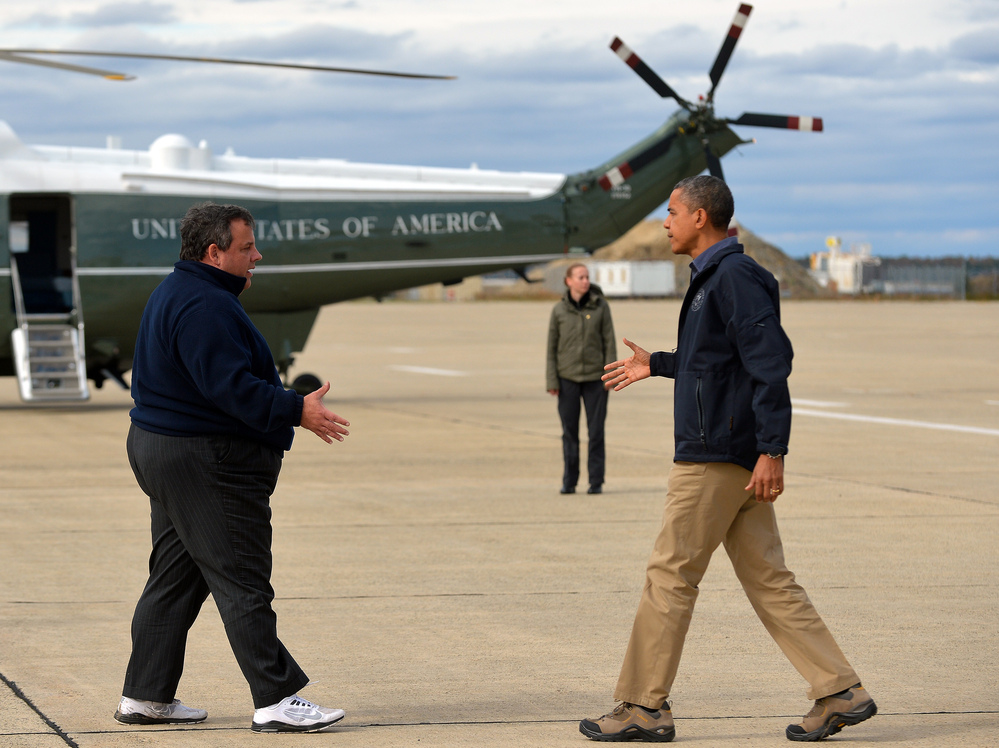President Obama (R) is greeted by New Jersey Governor Chris Christie upon arriving in Atlantic City, New Jersey, on Oct. 31, 2012 to visit areas hardest hit by Superstorm Sandy.