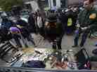 People wait to charge cellphones and laptops Thursday at a generator set up in the West Village. Superstorm Sandy left large parts of New York City without power.