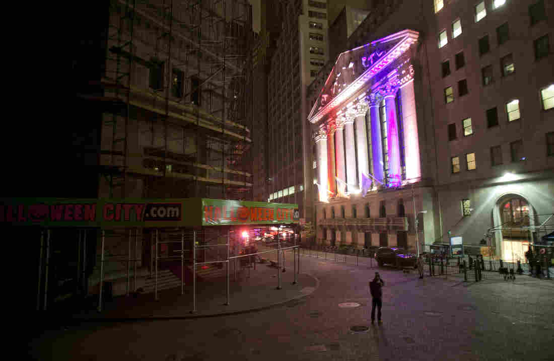 A man takes a photo of the New York Stock Exchange. A man takes a photo of the New York Stock Exchange.