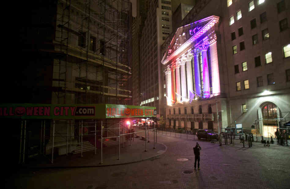 A man takes a photo of the New York Stock Exchange. A man takes a photo of the New York Stock Exchange.