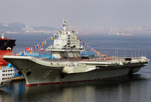 China's first aircraft carrier, shown here in the northeastern port of Dalian, was officially put into service on Sept. 25. The carrier is seen as a symbol of China's growing military might. China's first aircraft carrier, shown here in the northeastern port of Dalian, was officially put into service on Sept. 25. The carrier is seen as a symbol of China's growing military might.