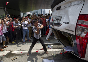 As part of a demonstration against Japan, a Chinese protester destroys a Japanese-model police car in Shenzhen, in southern China on Aug. 19, 2012. As part of a demonstration against Japan, a Chinese protester destroys a Japanese-model police car in Shenzhen, in southern China on Aug. 19, 2012.