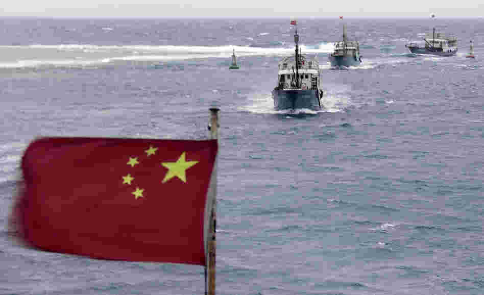 China is currently involved in several disputes with its neighbors over small islands, many of them uninhabited. Here, Chinese fishing boats sail off the island province of Hainan in the South China Sea in July. China is currently involved in several disputes with its neighbors over small islands, many of them uninhabited. Here, Chinese fishing boats sail off the island province of Hainan in the South China Sea in July.
