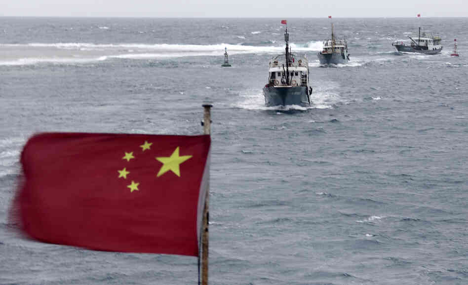 China is currently involved in several disputes with its neighbors over small islands, many of them uninhabited. Here, Chinese fishing boats sail off the island province of Hainan in the South China Sea in July. China is currently involved in several disputes with its neighbors over small islands, many of them uninhabited. Here, Chinese fishing boats sail off the island province of Hainan in the South China Sea in July.