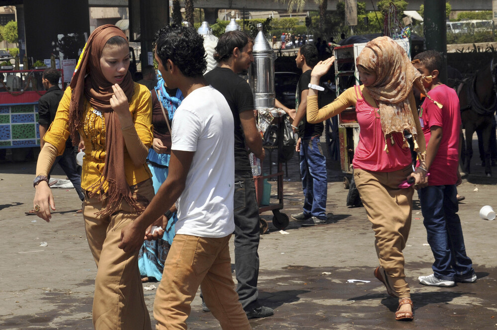 Young Egyptian men harasses Egyptian women recently in Cairo. Such episodes surged during a Muslim holiday last month.