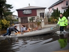An emergency responder helps residents of Little Ferry, N.J., after their neighborhood was flooded due to Superstorm Sandy. An emergency responder helps residents of Little Ferry, N.J., after their neighborhood was flooded due to Superstorm Sandy.
