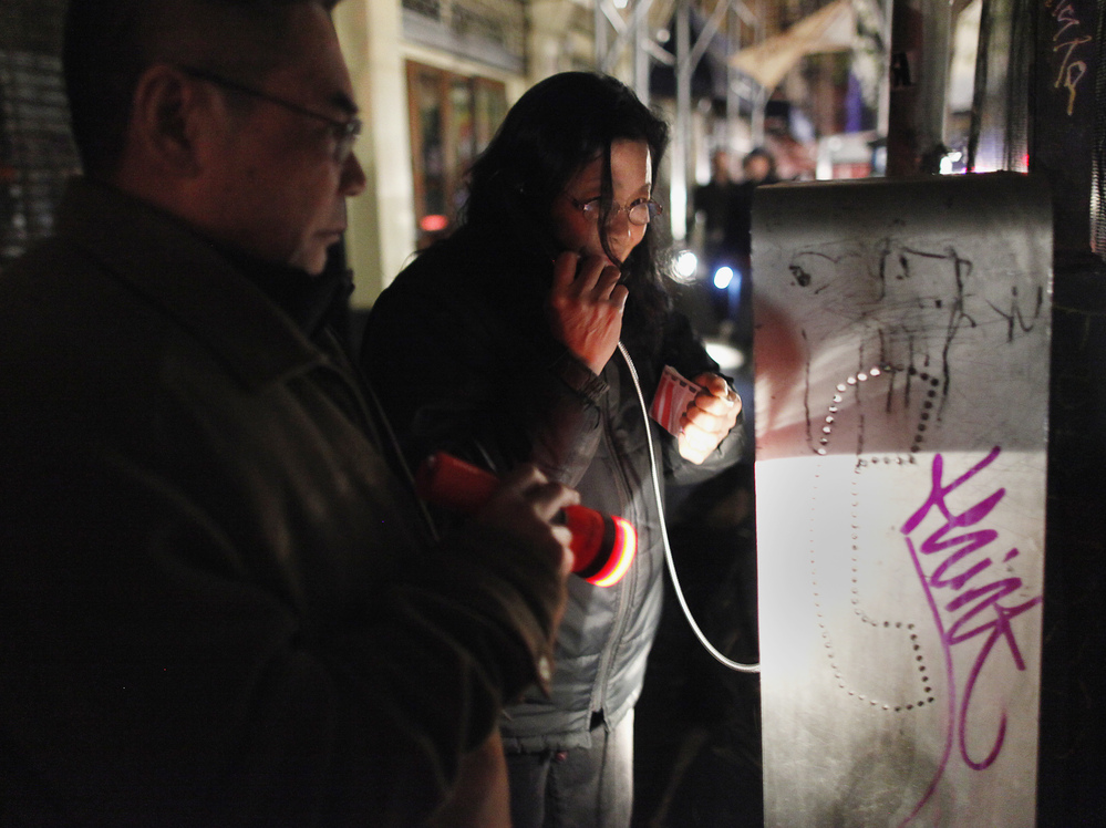 A woman uses a pay phone in the Lower East Village in Manhattan on Wednesday.