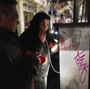 A woman uses a pay phone in the Lower East Village in Manhattan on Wednesday.